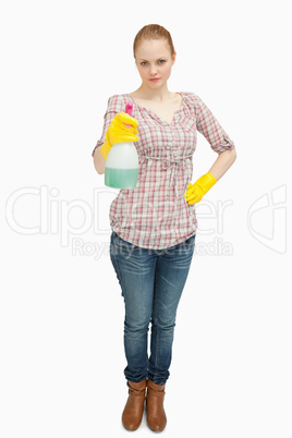 Woman standing while holding a spray bottle