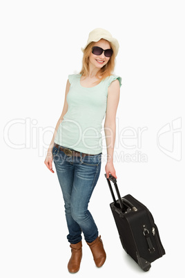 Woman holding a suitcase while standing