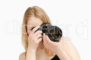 Woman taking a photography with a single-lens reflex camera