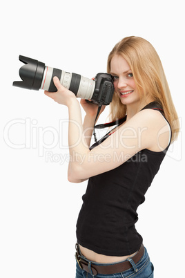 Joyful woman holding a SLR camera