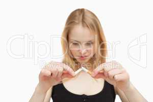 Fair-haired woman braking a cigarette