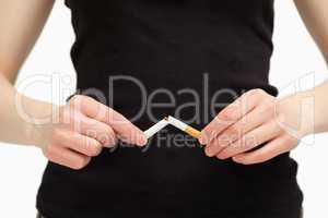 Close up of hands breaking a cigarette