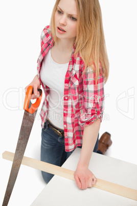 Woman using a wood saw