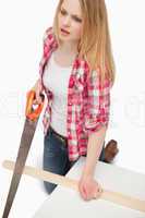 Woman using a wood saw