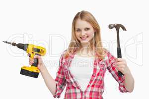 Smiling woman holding tools