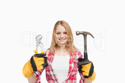 Woman holding tools while smiling