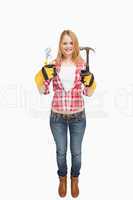 Woman standing while holding tools