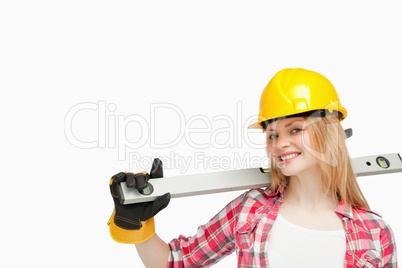 Woman smiling while holding a spirit level