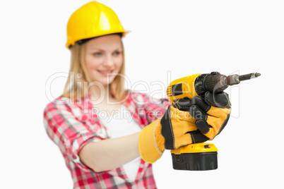 Cheerful woman using an electric screwdriver
