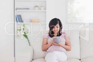 Woman relaxing as she sits on a sofa