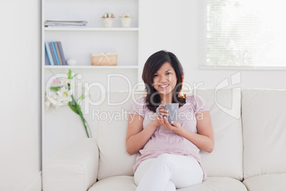 Smiling woman sitting on a sofa