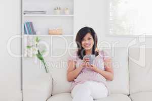 Smiling woman sitting on a sofa