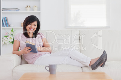 Smiling woman lying on a sofa