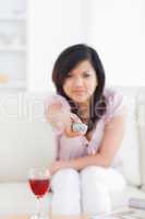 Blurred woman holding a television remote