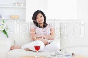 Woman smiling while sitting on a couch