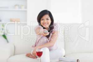 Woman holding a remote while sitting