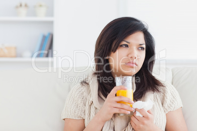 Sick woman holding a glass of orange juice