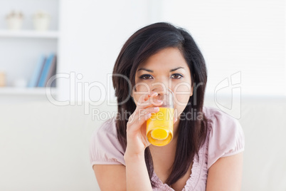 Woman drinking a glass of orange juice