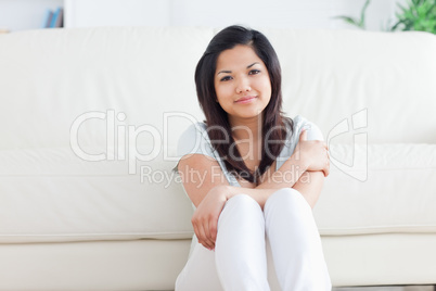 Smiling woman sitting on the floor