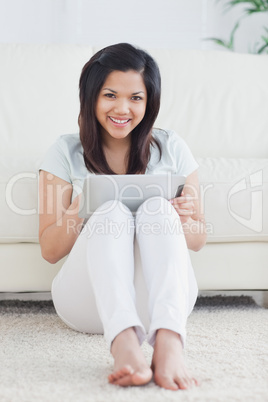 Woman smiling and playing with a tactile tablet