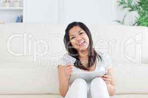 Woman laughs while she is holding a card and a tactile tablet