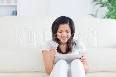 Woman sitting on the floor in front of a sofa