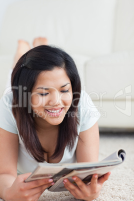 Woman smiles as she reads a magazine