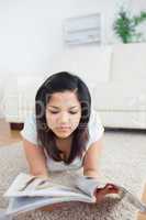 Woman reading a magazine on the floor