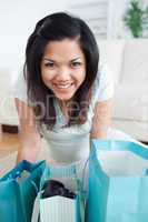 Smiling woman standing over shopping bags