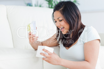 Woman smiling while looking at an open gift box
