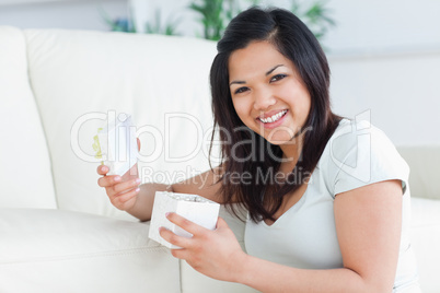 Woman smiling with an open gift box in her hands