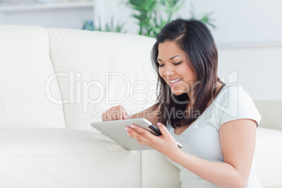 Smiling woman playing with a tactile tablet