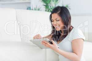 Smiling woman playing with a tactile tablet