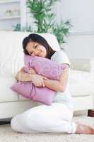 Woman holding tight a pillow