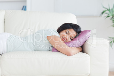 Woman sleeping on a couch with a pillow