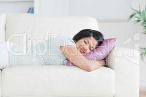 Woman sleeping on a couch with a pillow