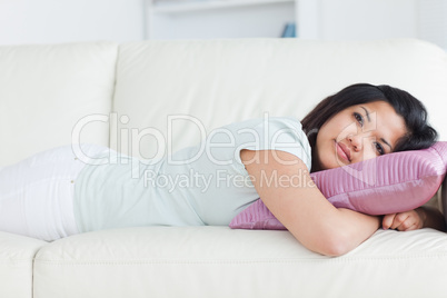 Woman on a sofa with her head resting on a pillow