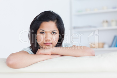 Woman crossing her arms on a white couch
