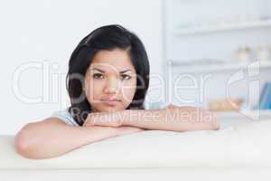 Woman crossing her arms on a white couch