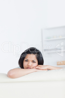Woman resting her face on a sofa