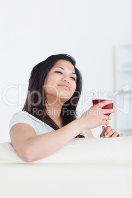 Woman holding a glass of red wine with two hands