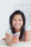 Smiling woman holding a credit card