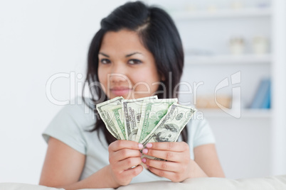 Woman holding four dollar bills