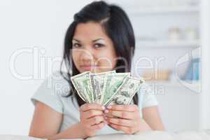 Woman holding four dollar bills