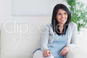 Smiling woman relaxing on a sofa