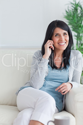 Woman smiling while talking on the phone