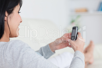 Woman smiling while typing on a phone