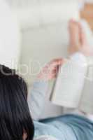 Blurred view of a woman reading a book