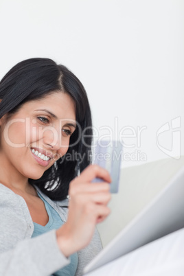 Woman looking at a tactile tablet while holding a card