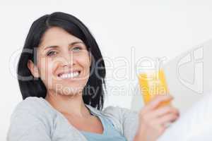 Smiling woman holding a glass of juice